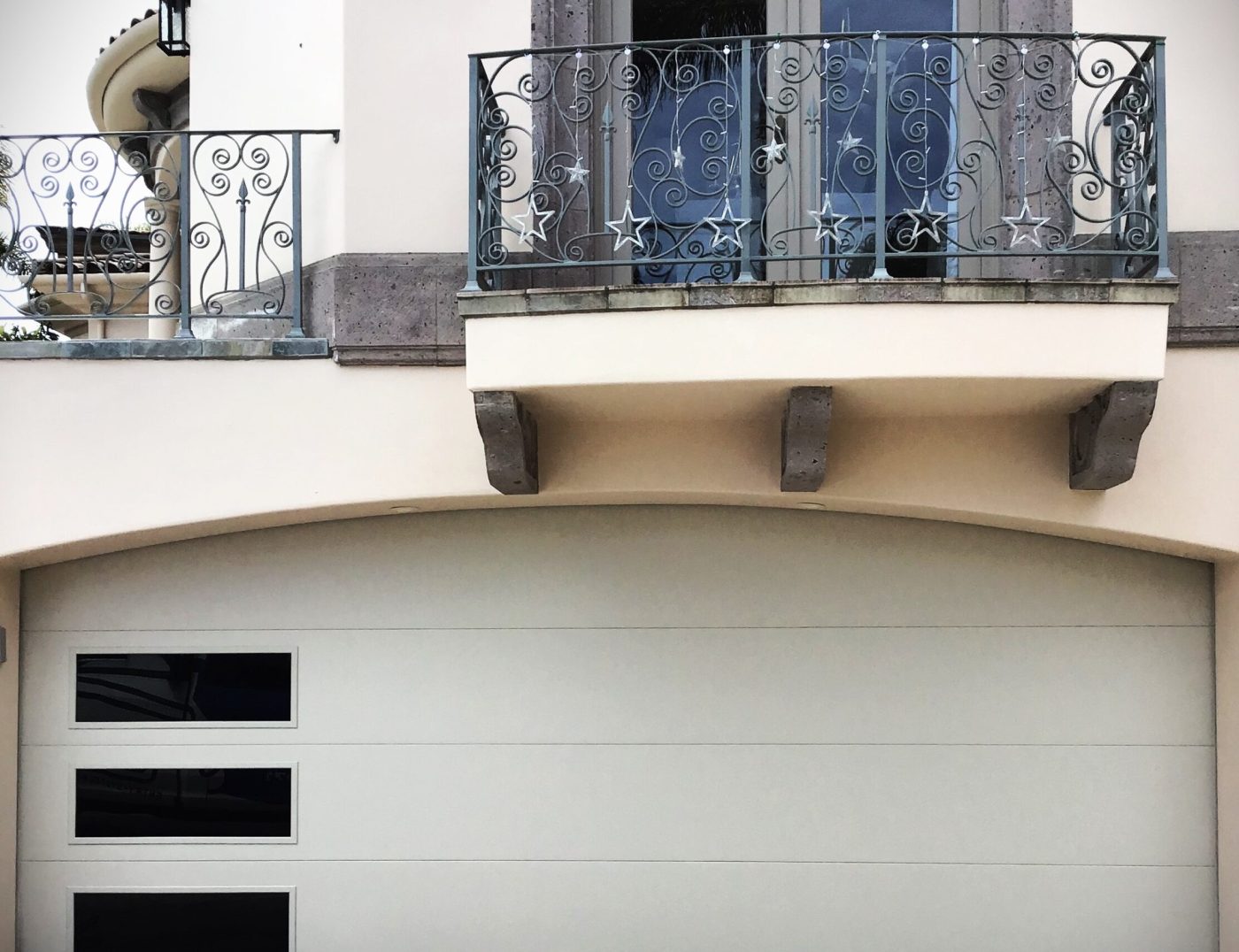 This is a beige flush modern garage door replacement in Newport Beach, CA.