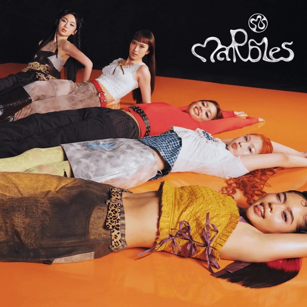 five-member girl group Marbles, three lying down and two leaning against their arms