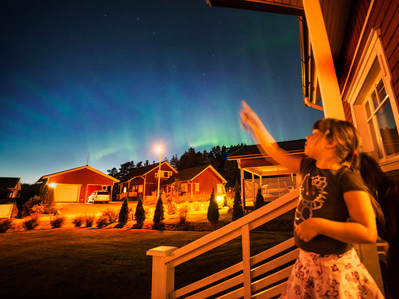 A girl pointing at the night sky