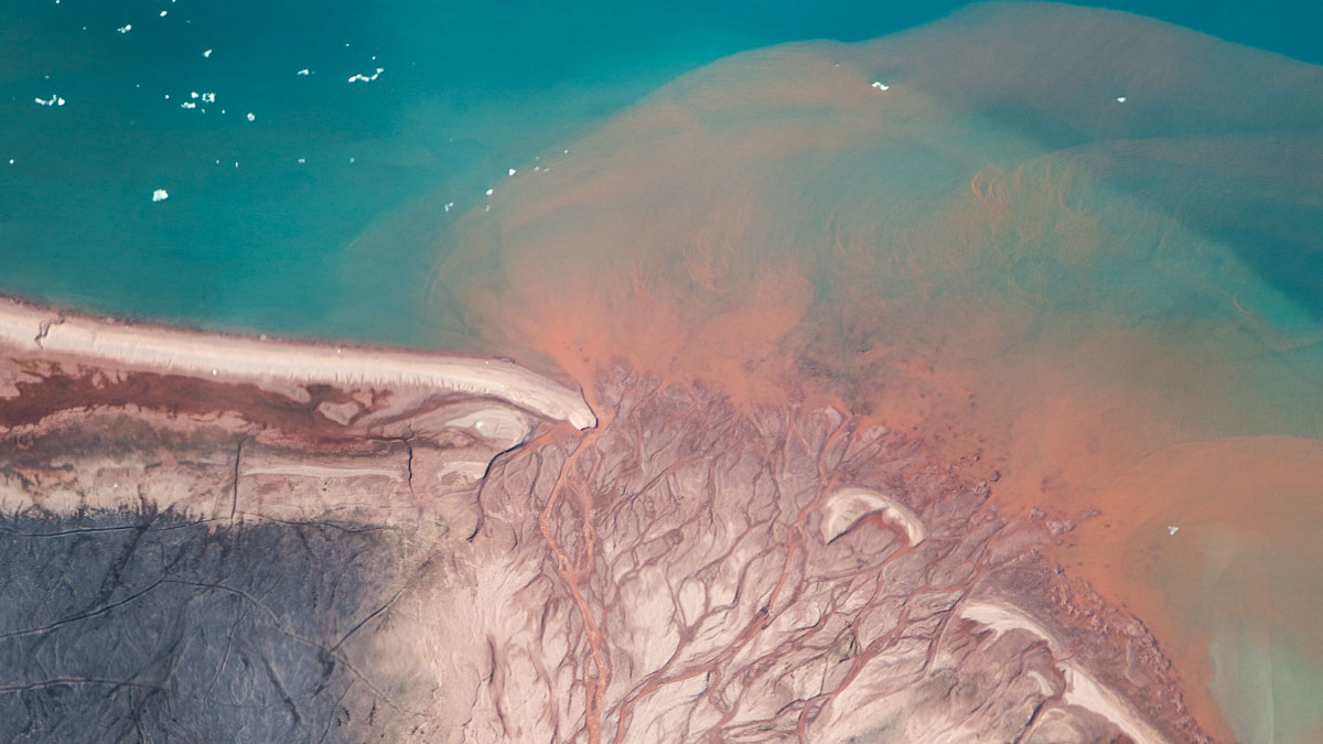 Sand drains from an unnamed river into Murchison Sound close to Qaanaaq in northwestern Greenland