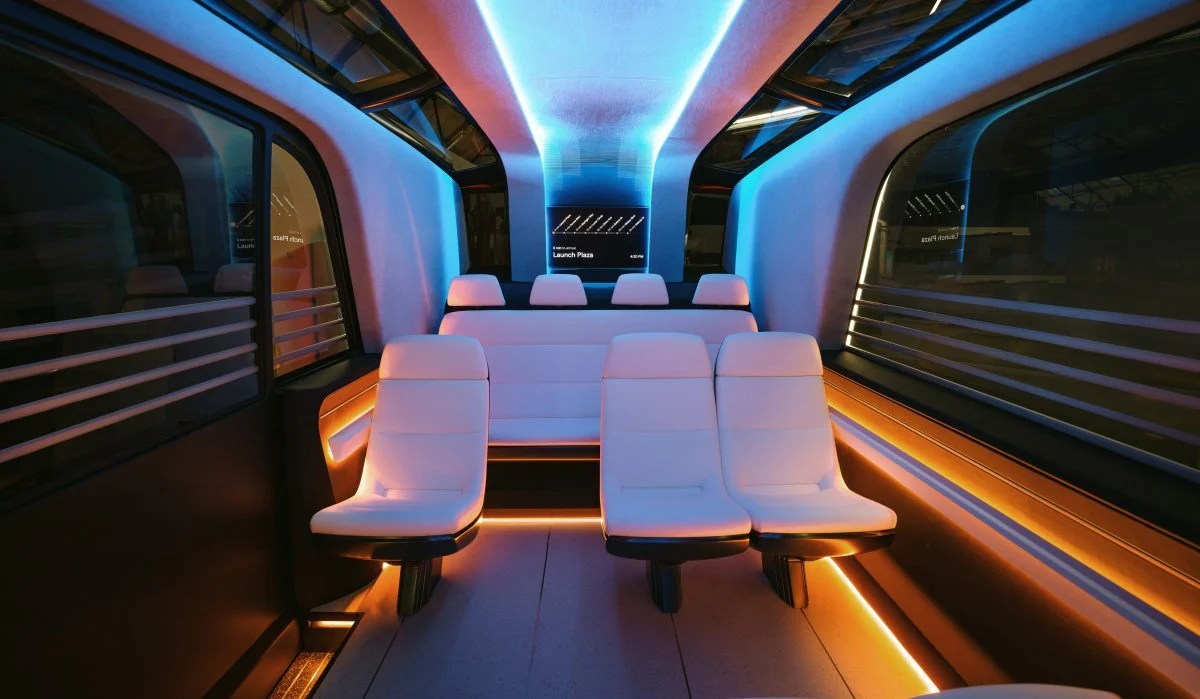 Tesla Robotaxi interior featuring futuristic white seats with ambient blue and orange lighting