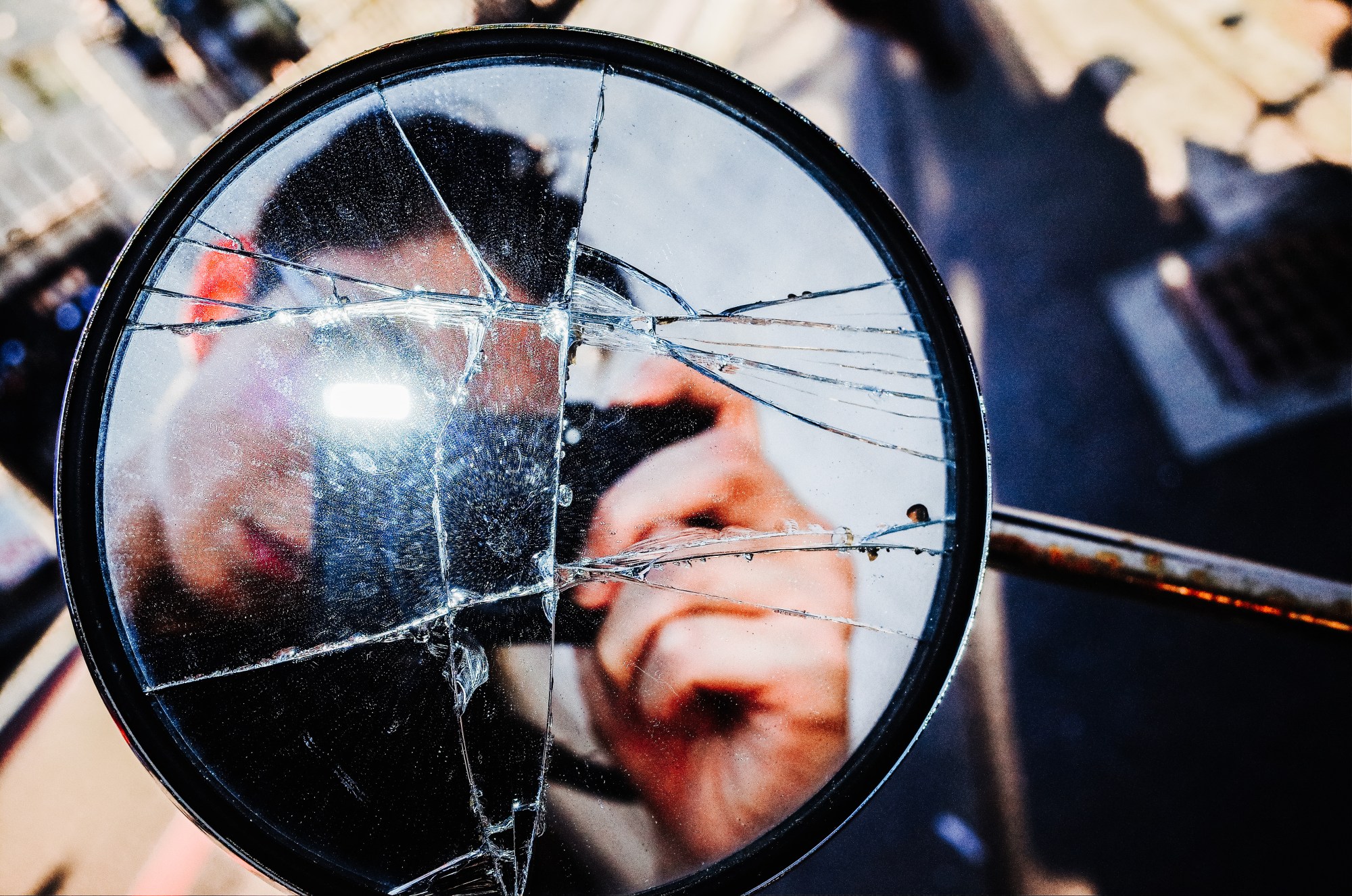 Selfie through broken glass with flash.