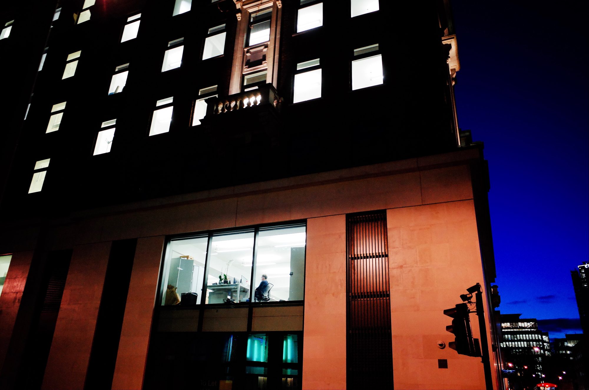 Man in office building at night. London, 2018