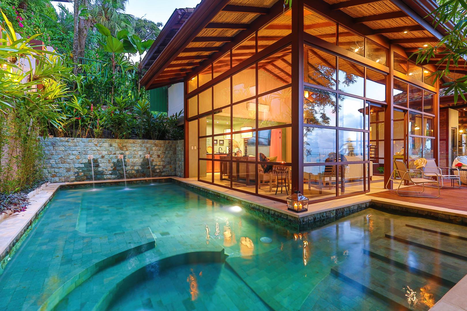Private pool beside the new glass-walled living wing surrounded by tropical greenery