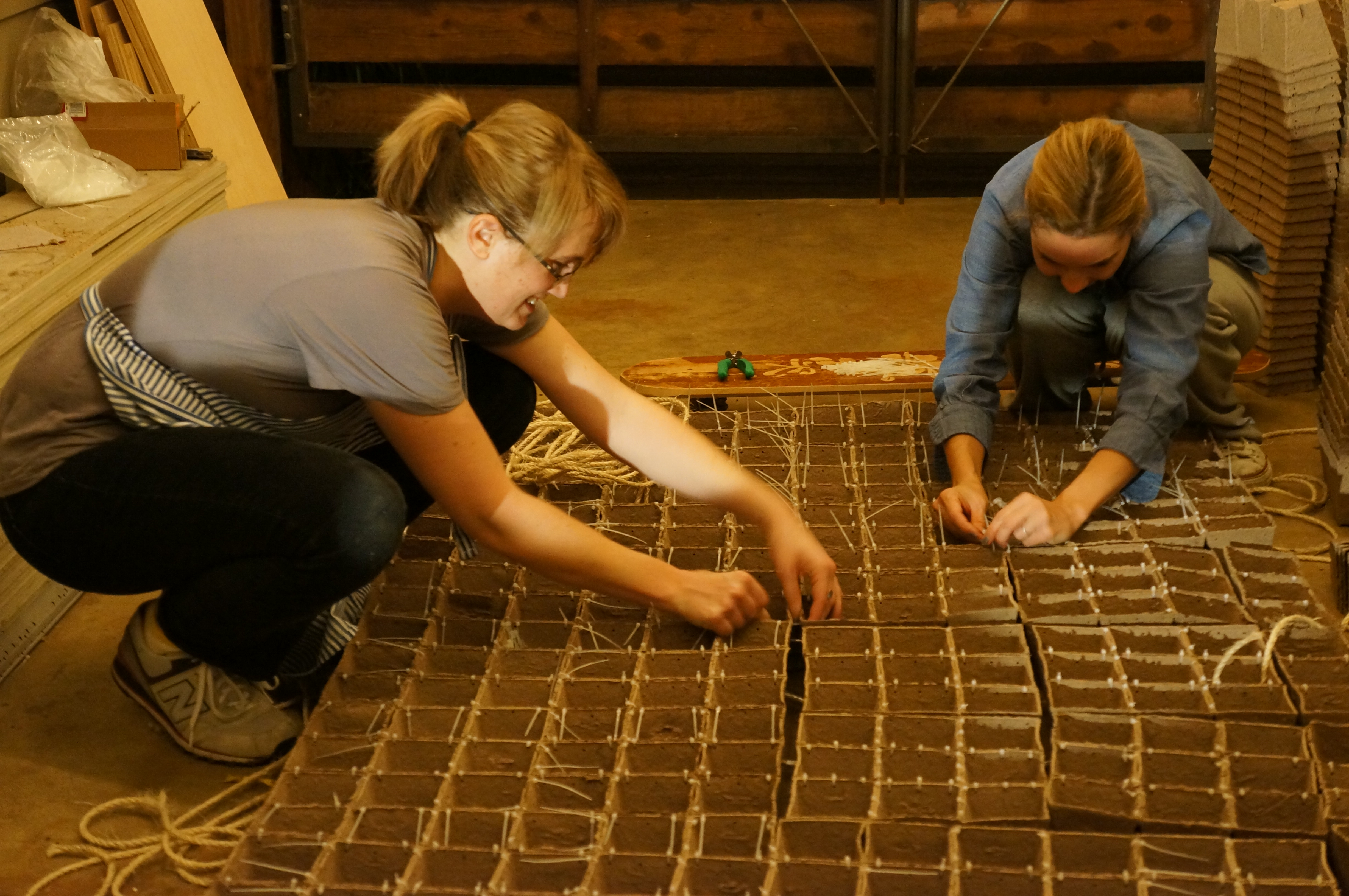 Emily and Alisa assemble one wall