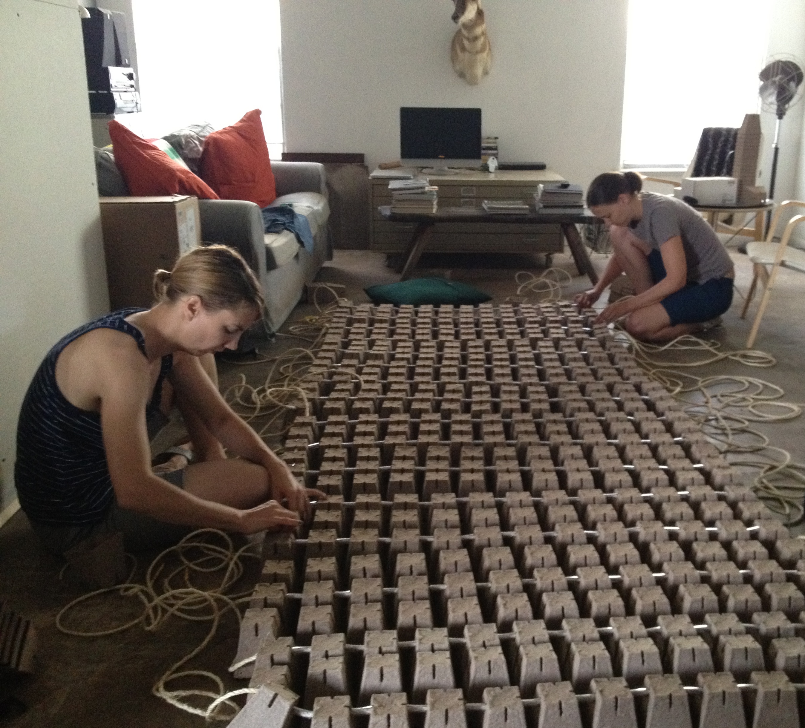 Margaret and Alisa assemble one of the four vertical walls