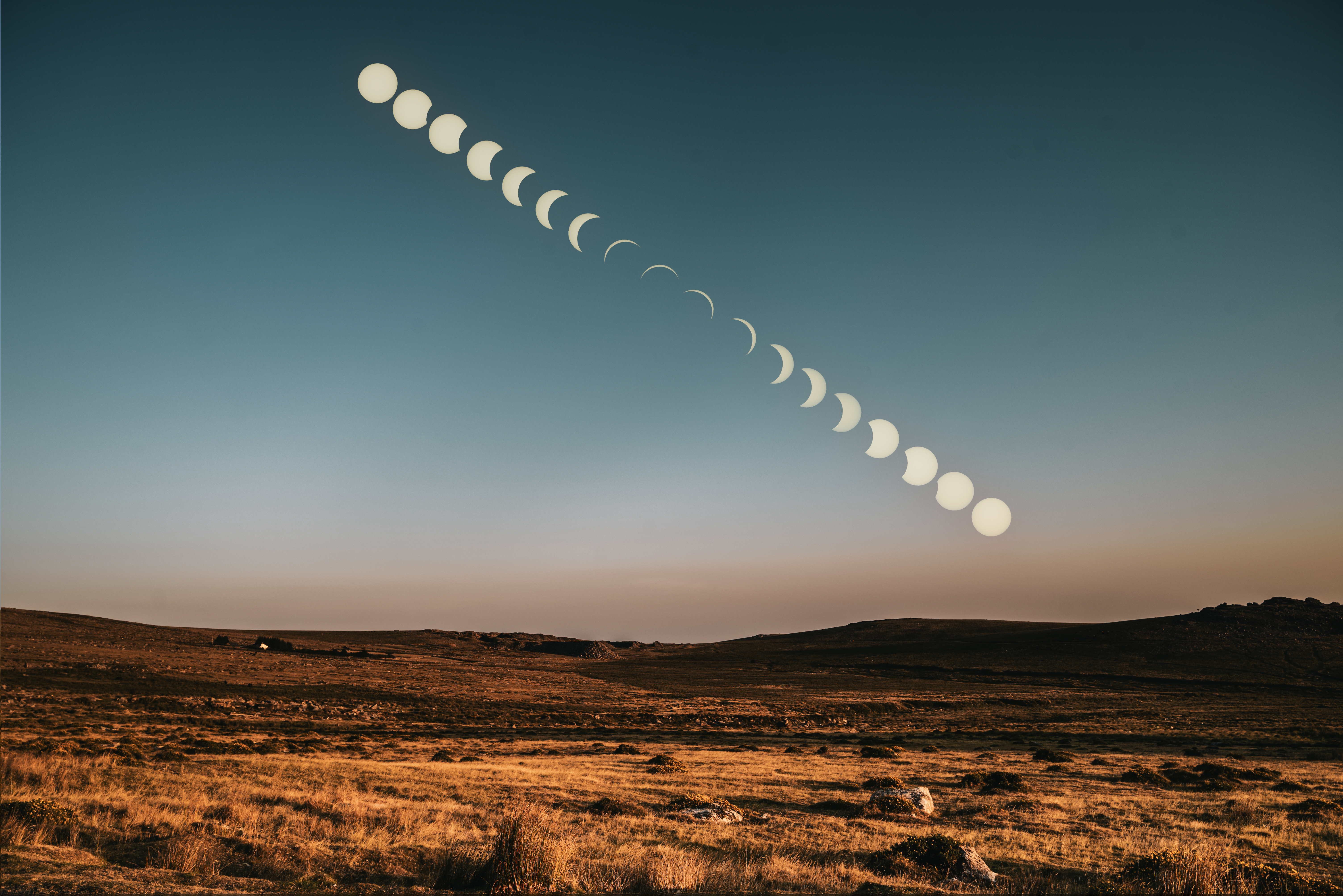 Solar eclipse sequence forming a diagonal progression over the Dartmoor landscape at sunset.