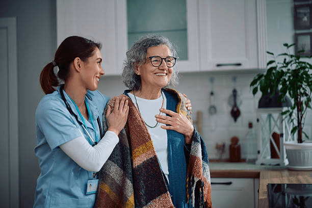 Happy senior woman enjoying in a visit of home caregiver.