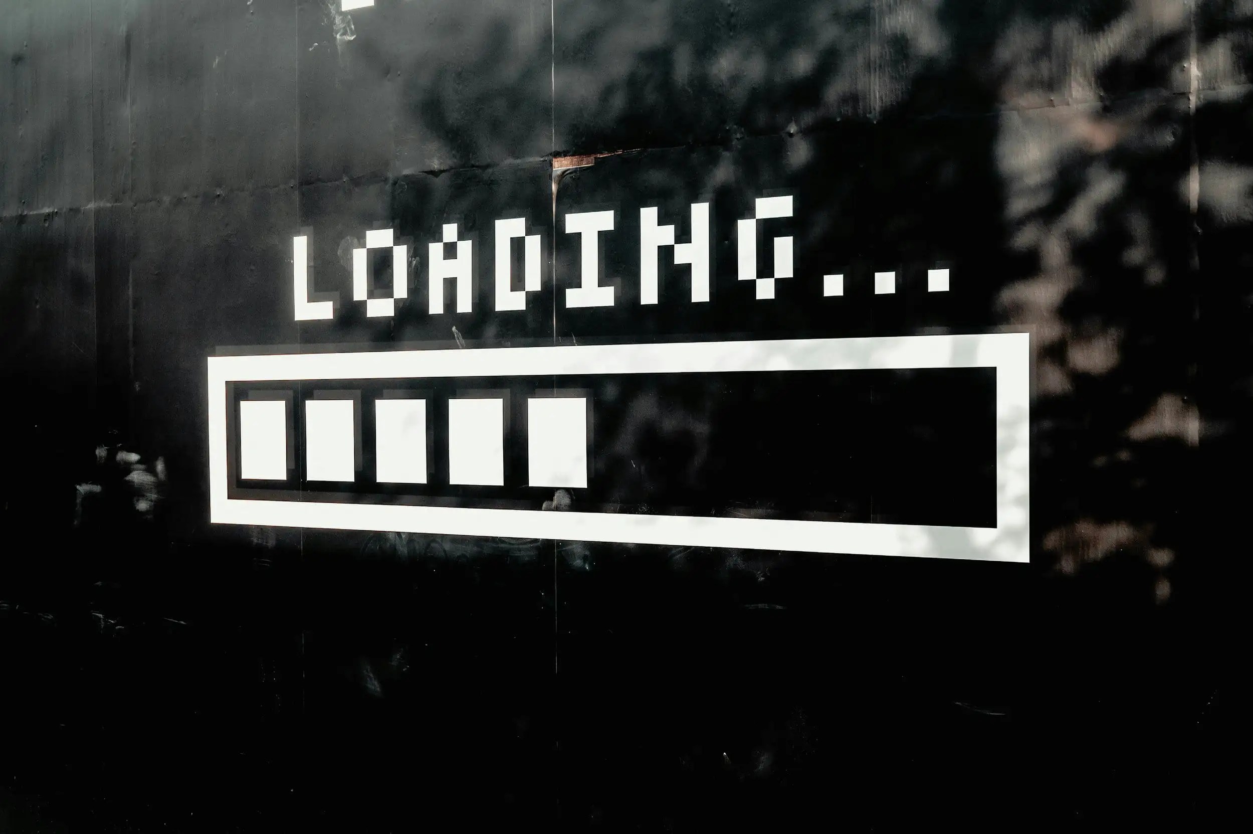 Pixelated "LOADING..." text with a progress bar on a black background.
