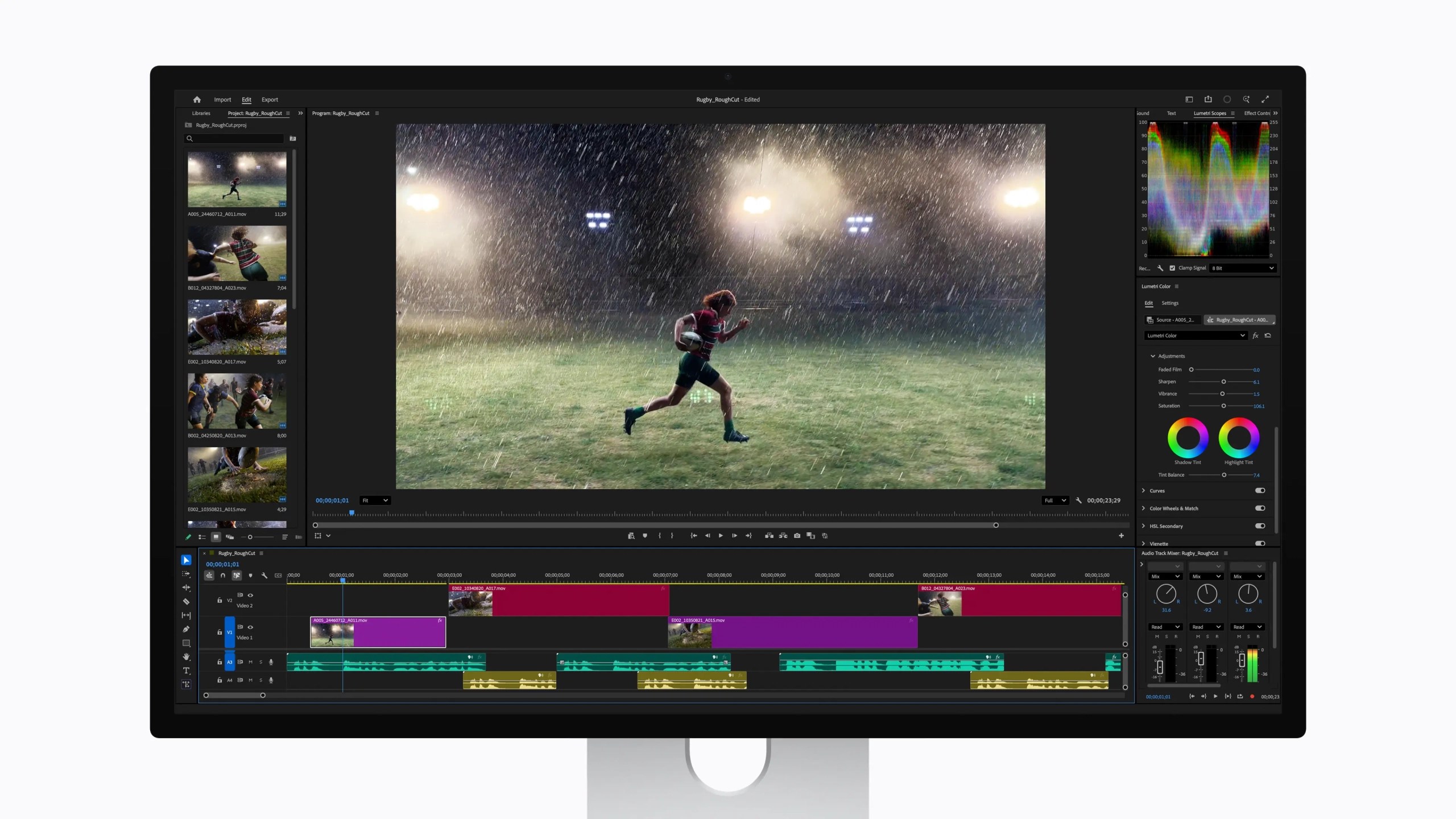 A computer screen displaying video editing software with a rugby player running during a rainstorm, flanked by clips in the timeline below.