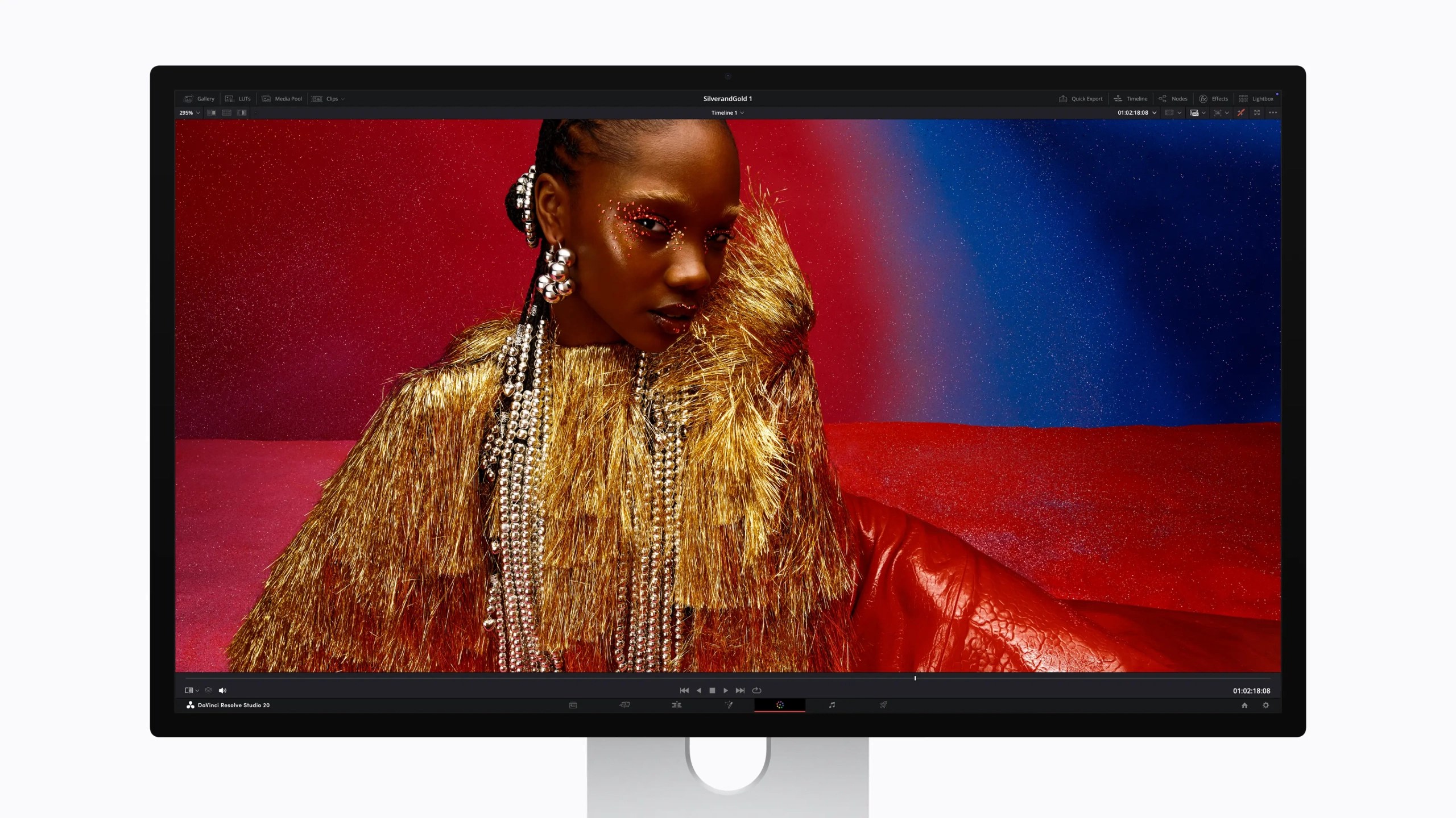 A digital display showcasing a close-up portrait of a person with intricate styling, wearing a vibrant golden outfit and decorative jewelry against a colorful background.