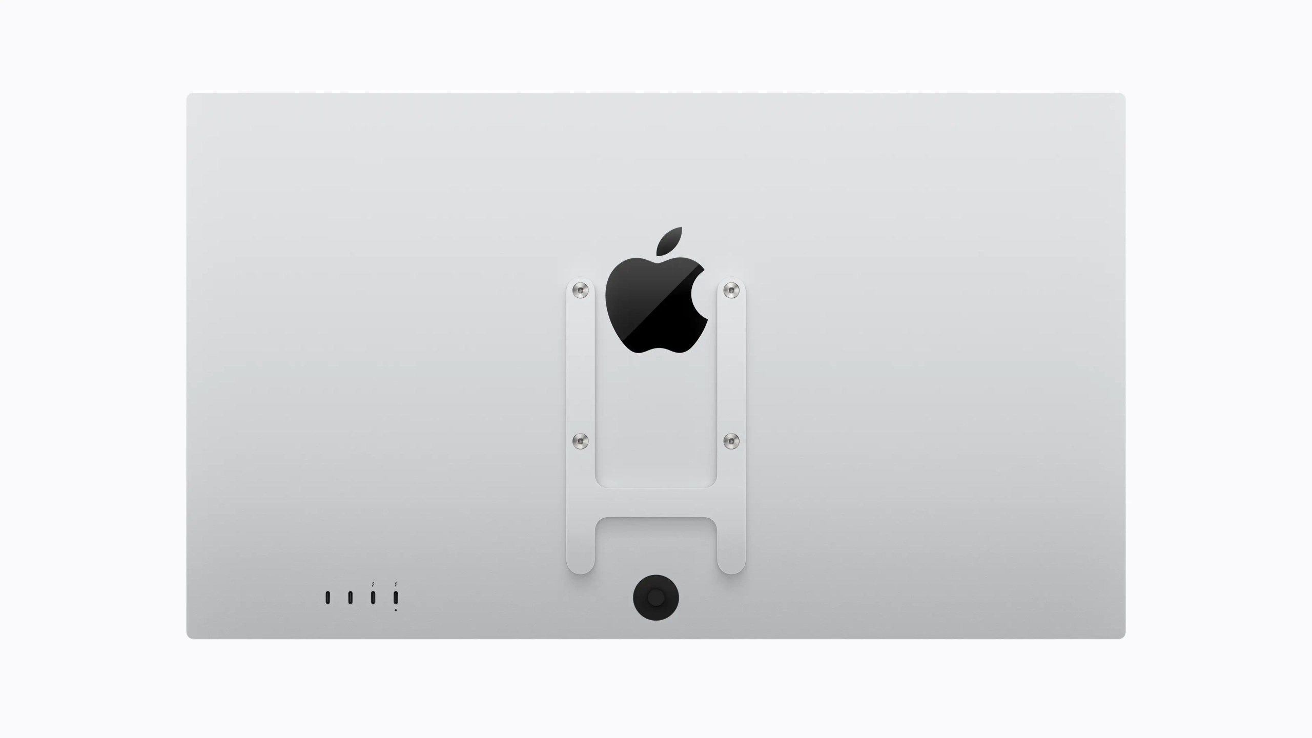 Back view of a sleek Apple monitor featuring the Apple logo at the center, along with a mounting bracket and connectivity ports at the bottom.