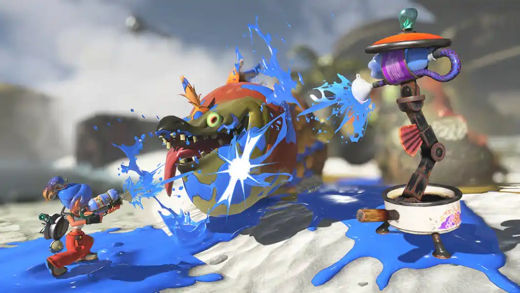 An Inkling character shoots blue ink at a large, monstrous fish creature in a Splatoon gameplay scene.