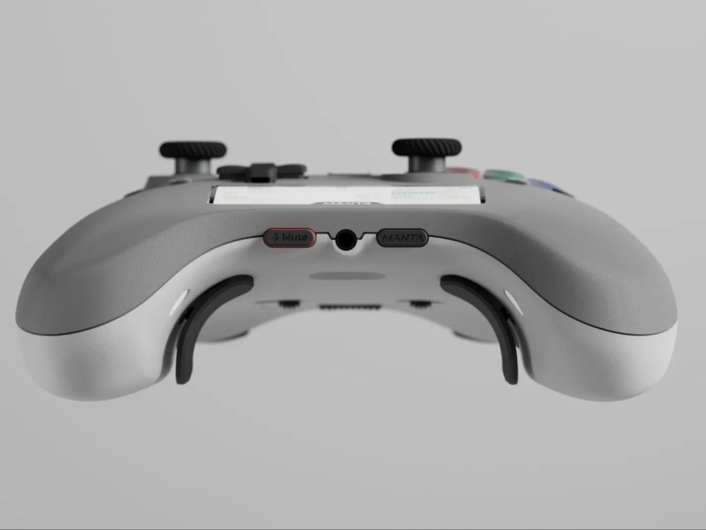 A bottom view of a gray gaming controller featuring a headphone jack, mute button, and back paddles.