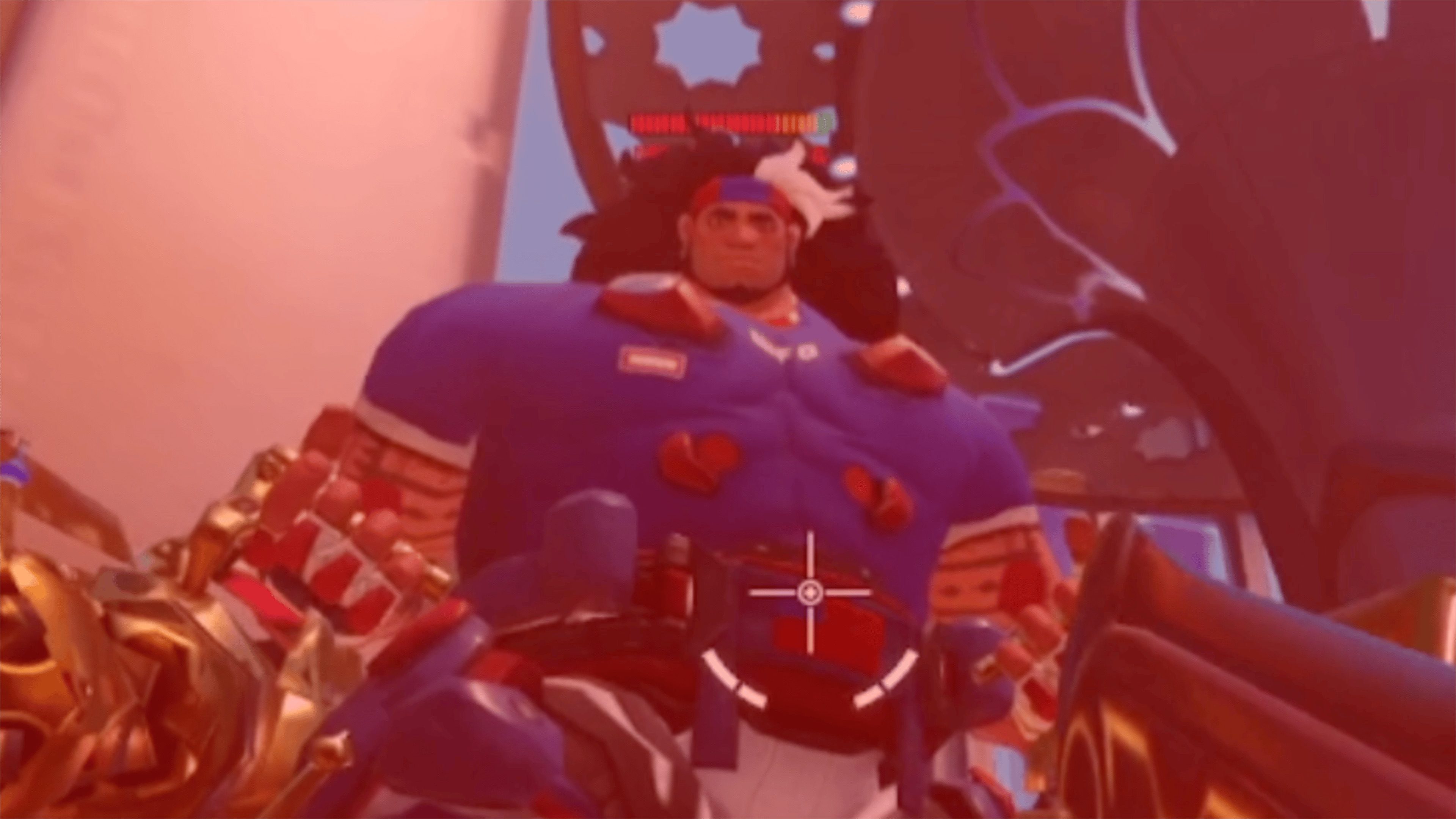 A muscular character model from Overwatch with a blue shirt and red accents, standing in a game environment.