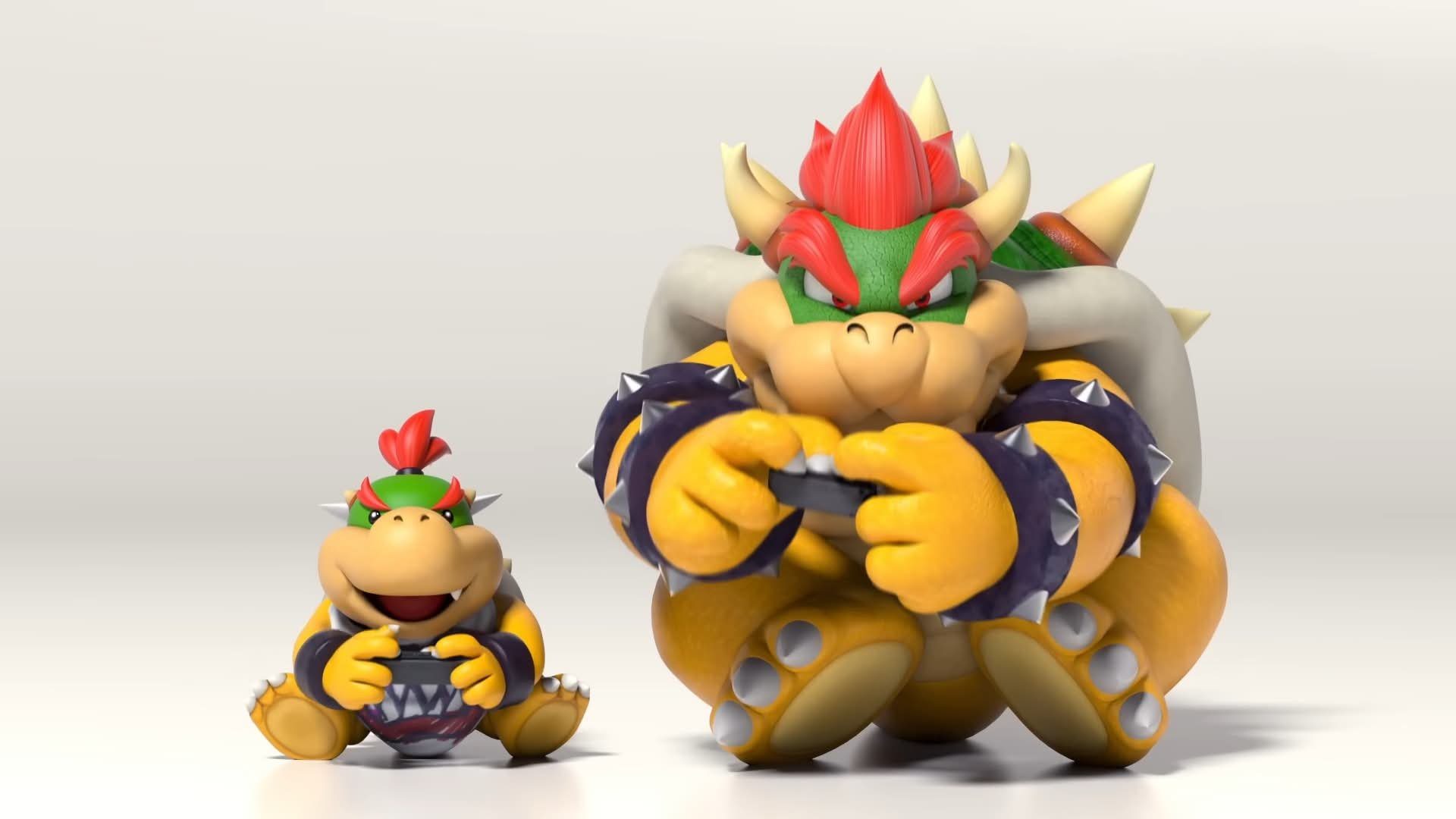 Bowser and Bowser Jr. sitting side by side on the floor, each holding a controller and playing a video game with focused expressions