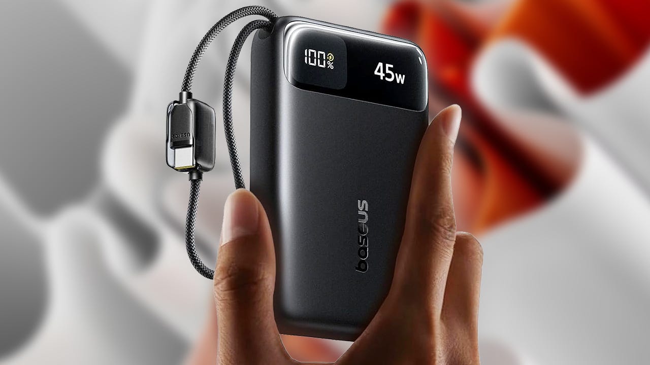 A hand holds a black Baseus power bank displaying a 100% charge and 45W output.