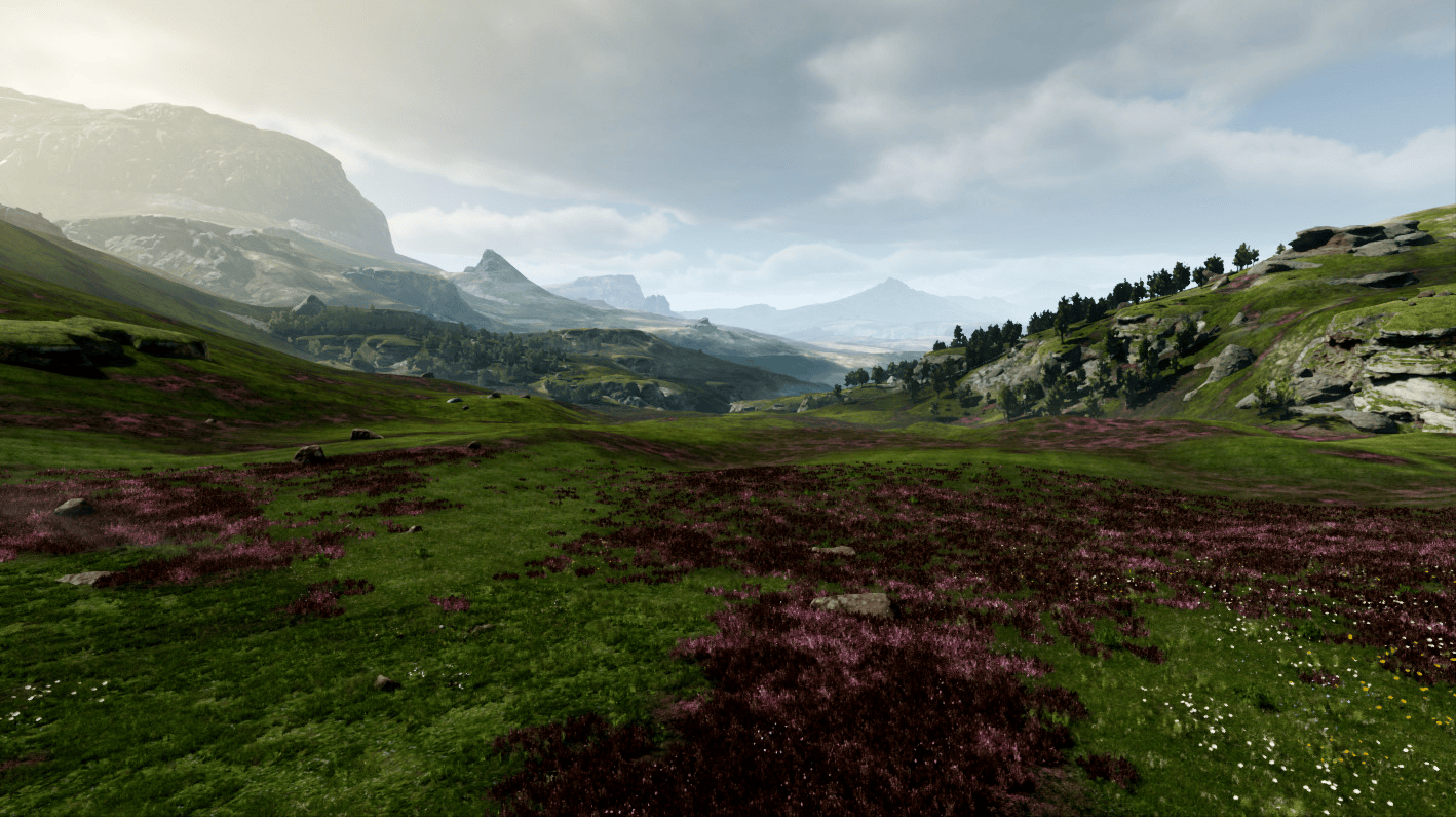 A vast green valley features patches of purple wildflowers beneath a cloudy sky and distant mountains.