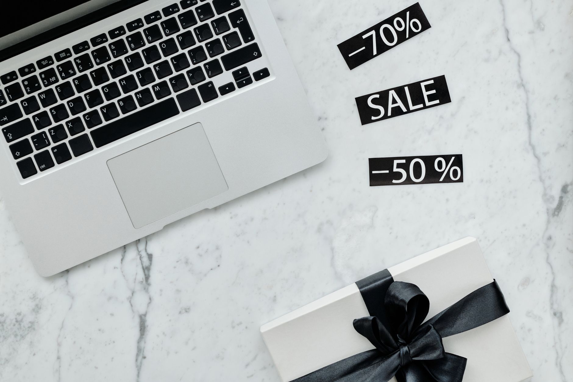 close up shot of a laptop beside discount tags