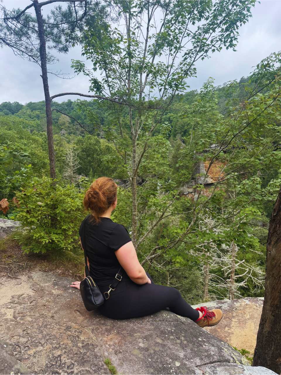 Kait sitting on rock formation on the Fall Creek Falls hike