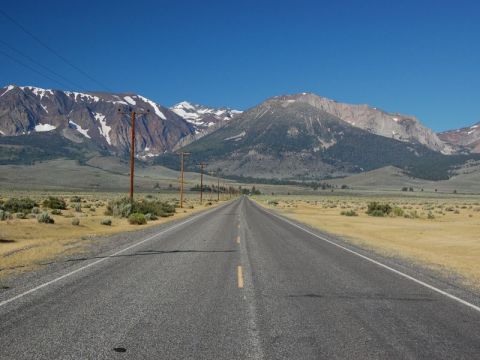 Straight road leading to mountains.