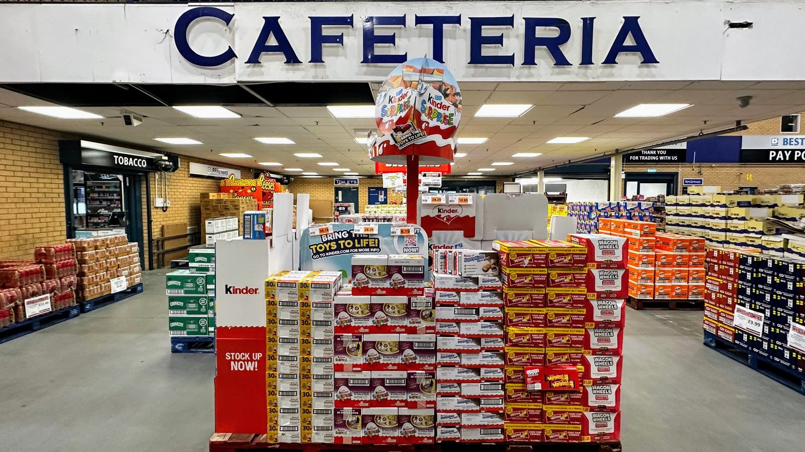 Executional staff checking Ferrero Rocher point of sale material in a UK store