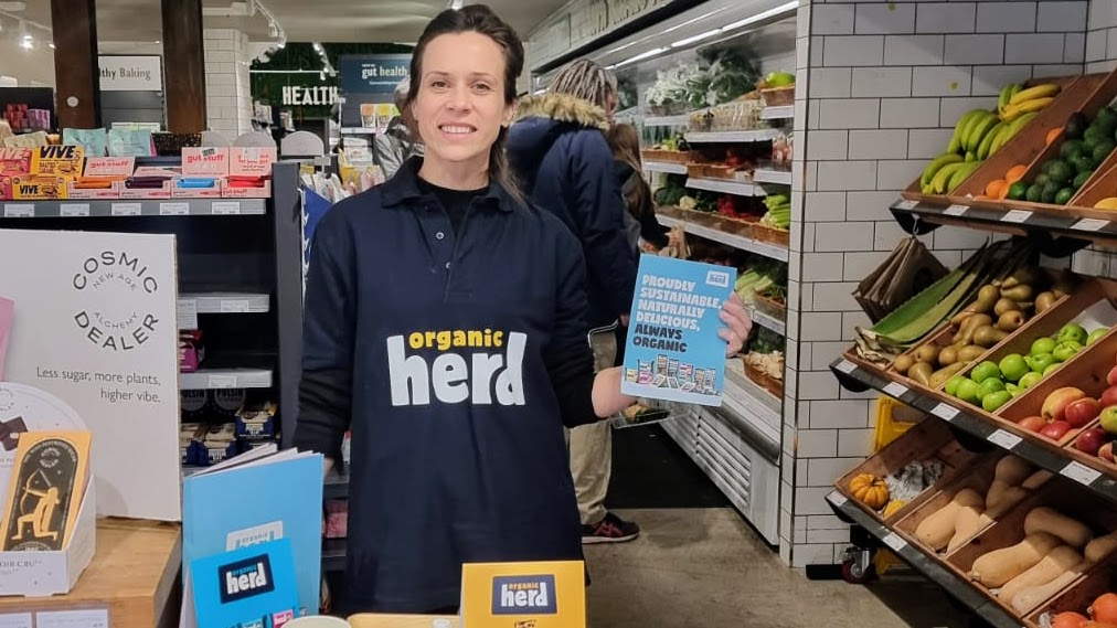 Executional promotional staff for Organic Herd at a tasting counter in Planet Organic