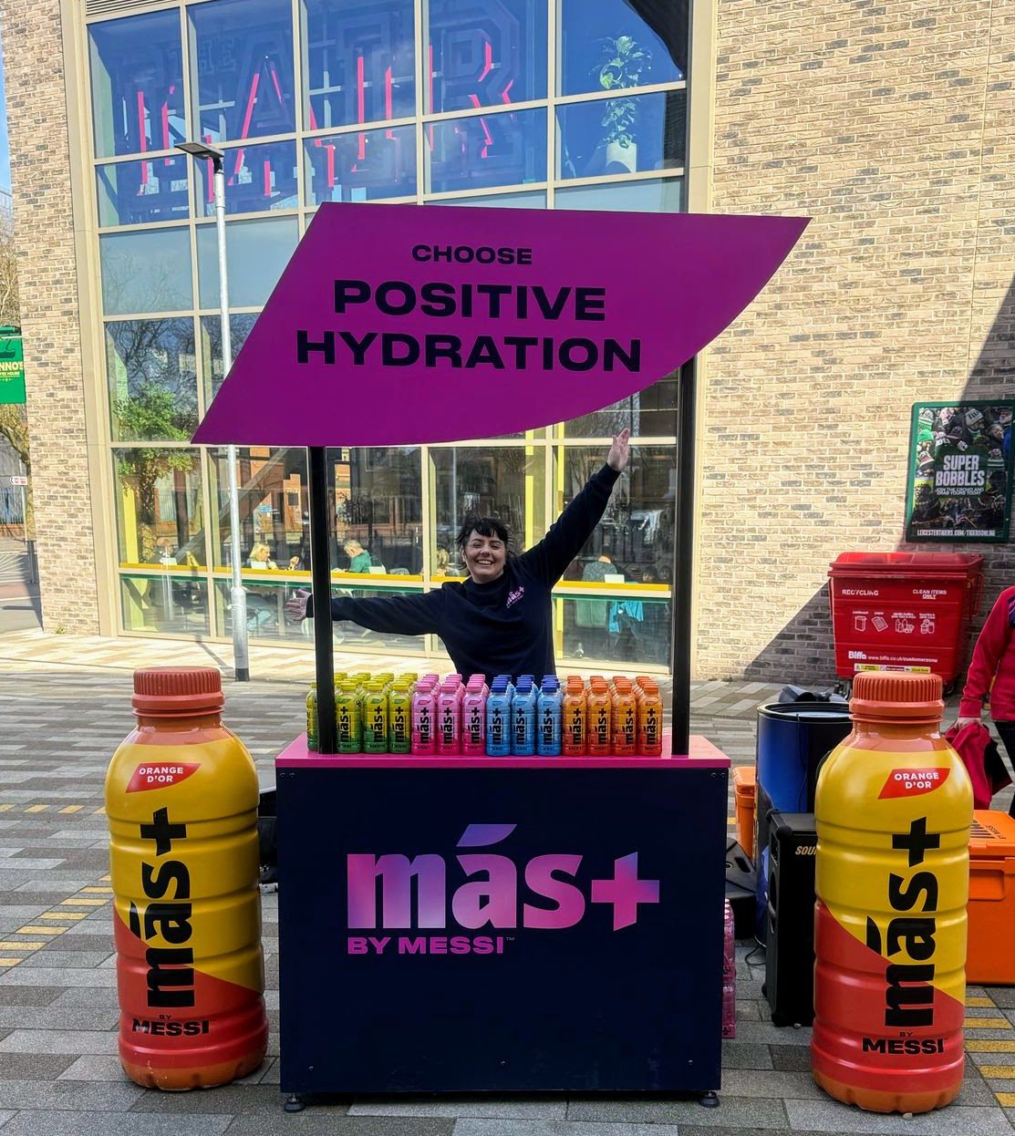 Mas+ hydration stall with an Executional promoter outside a store