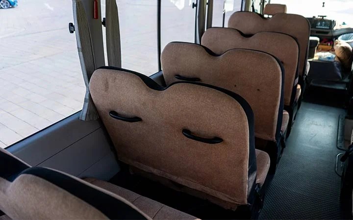 Rear seat view of Coaster bus with driver and fuel Qatar
