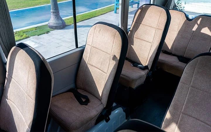 Comfortable seating inside Coaster bus with driver and fuel in Qatar