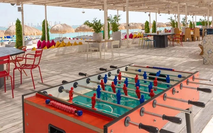 Foosball table and seating area at Doha Beach Club in West Bay Qatar
