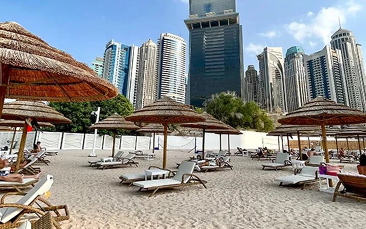 Sandy beach with city towers in Doha