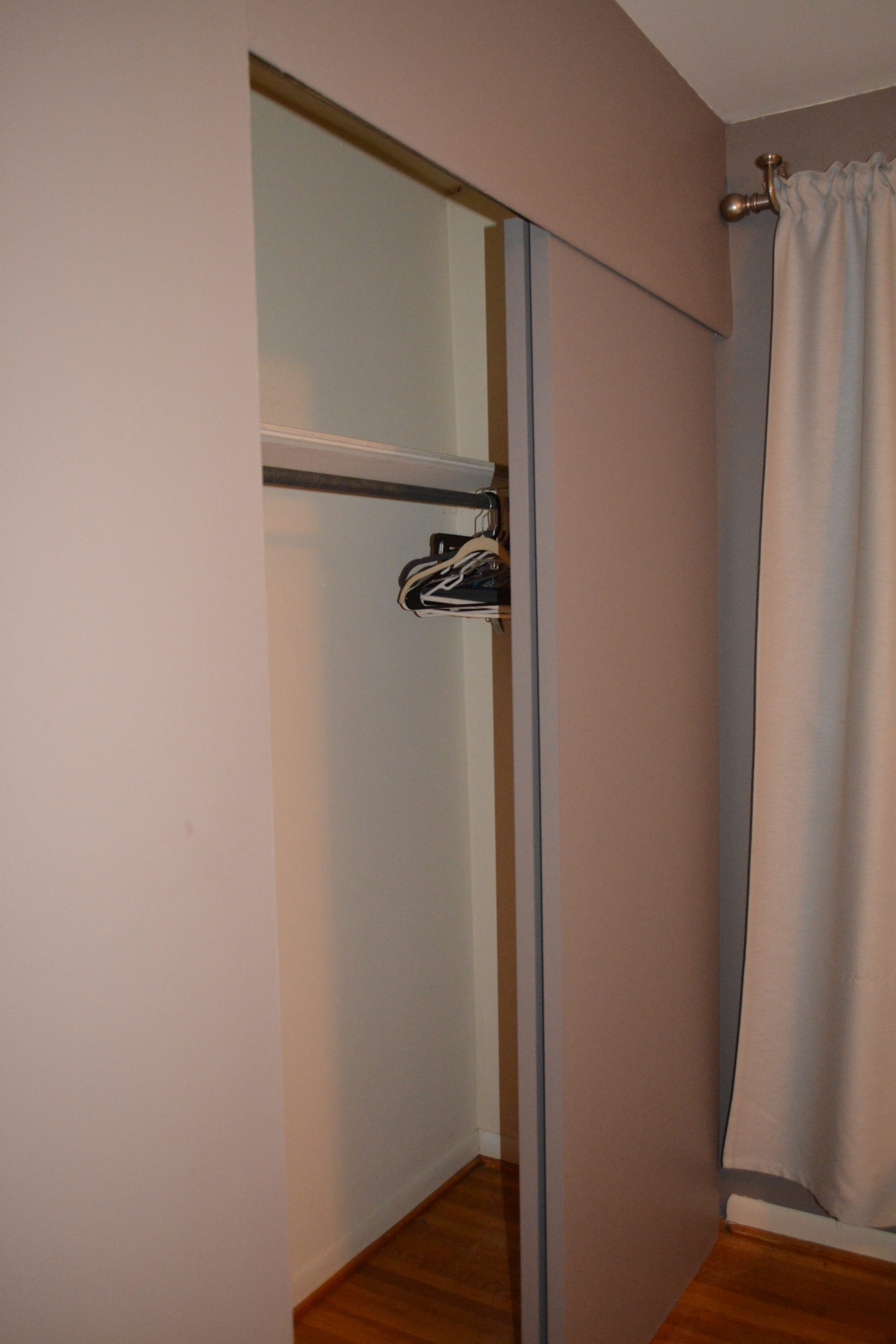 Closet before with sliding doors and gray paint.