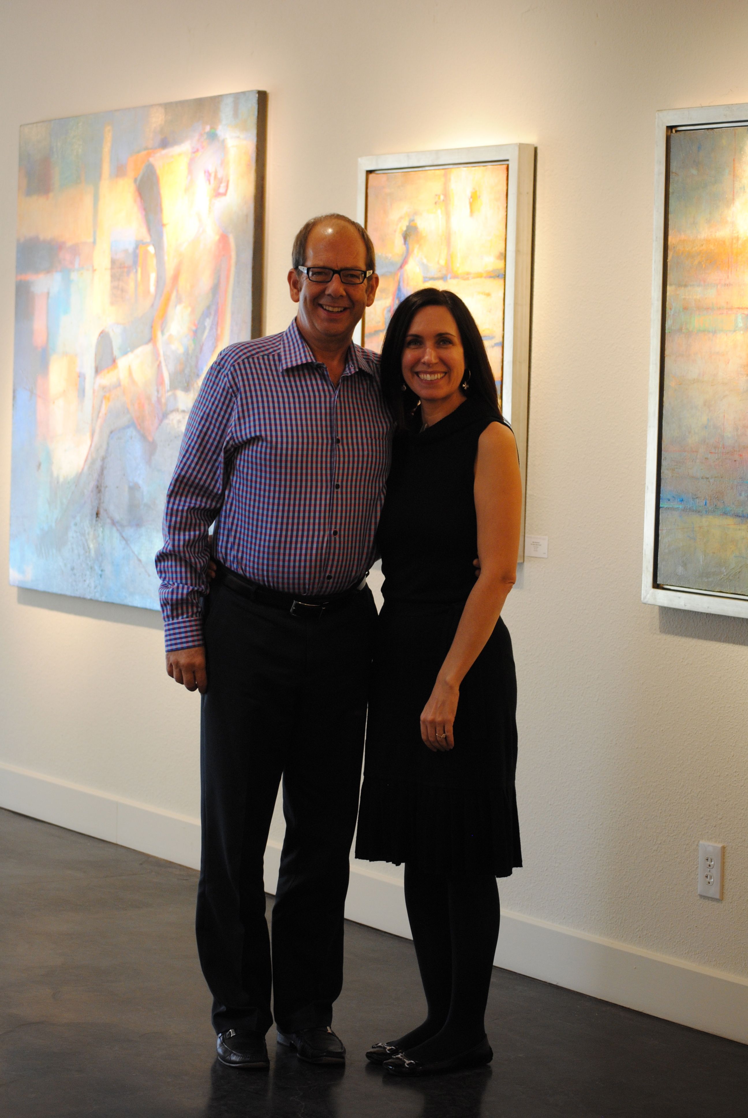 Clark Olson and Christi Bonner Manuelito of Bonner David Galleries, amid works by Max Hammond.