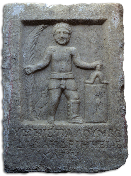 Rectangular gray slab with a bas relief of a man wearing a loincloth, arms extended on either side. A small dog and a large frond appear on the left. A Greek inscription has been carved below.