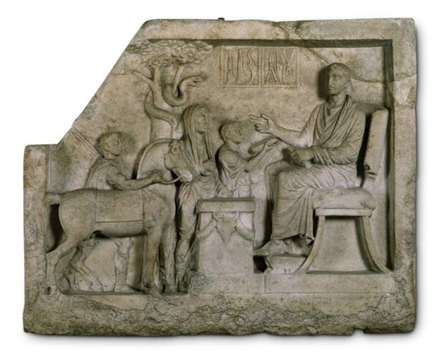 Gray horizontal rectangle carved with a scene in bas relief. Three figures queue before a man seated on a platform. Behind them is a tree with a snake in its branches. The top left corner of the relief has broken off.  