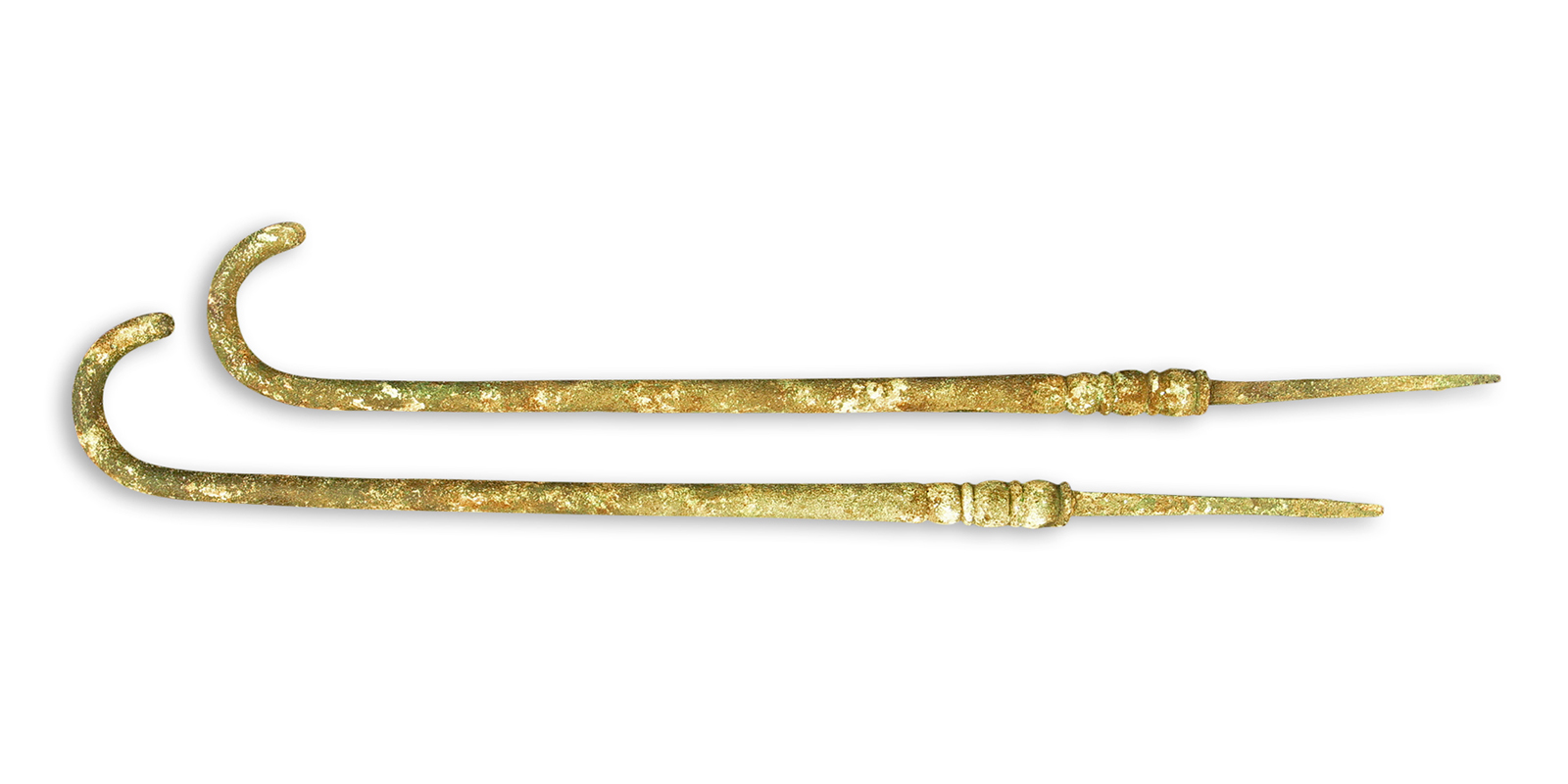Two ivory hooks with tapered ends. The base of the hooks feature carved decorations. 