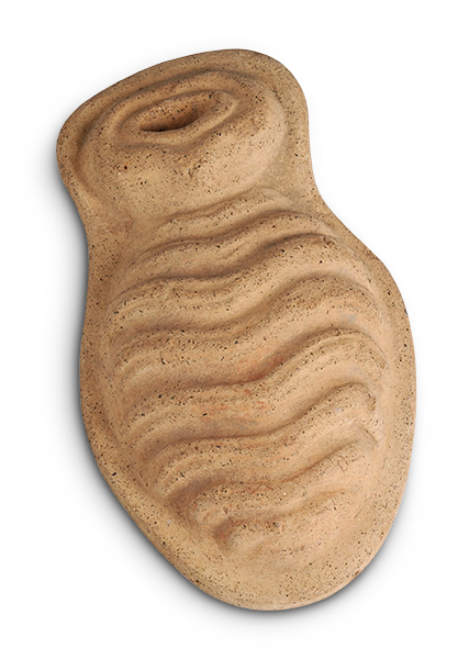 A light reddish-brown object shaped like a figure eight. Wavy lines are carved across the bottom portion. 