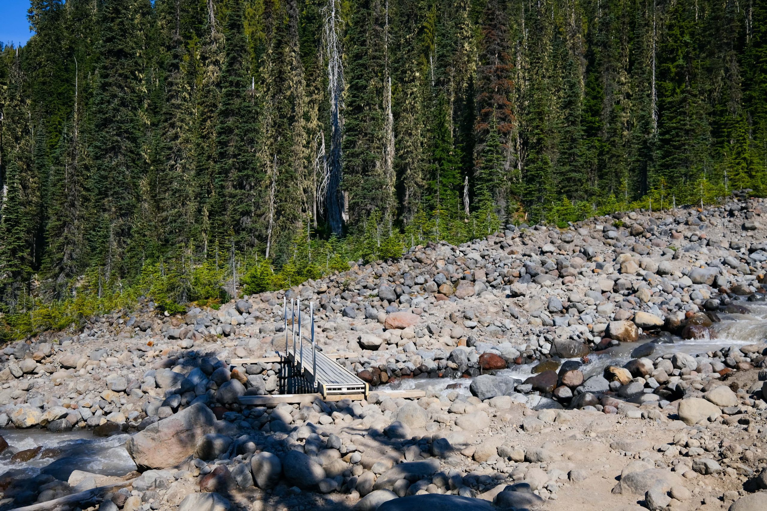 metal bridge across a river in a landslide area