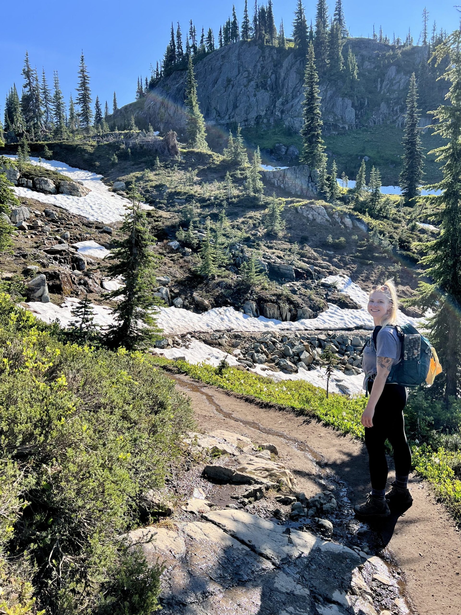 Women on a trail with snow and trees
