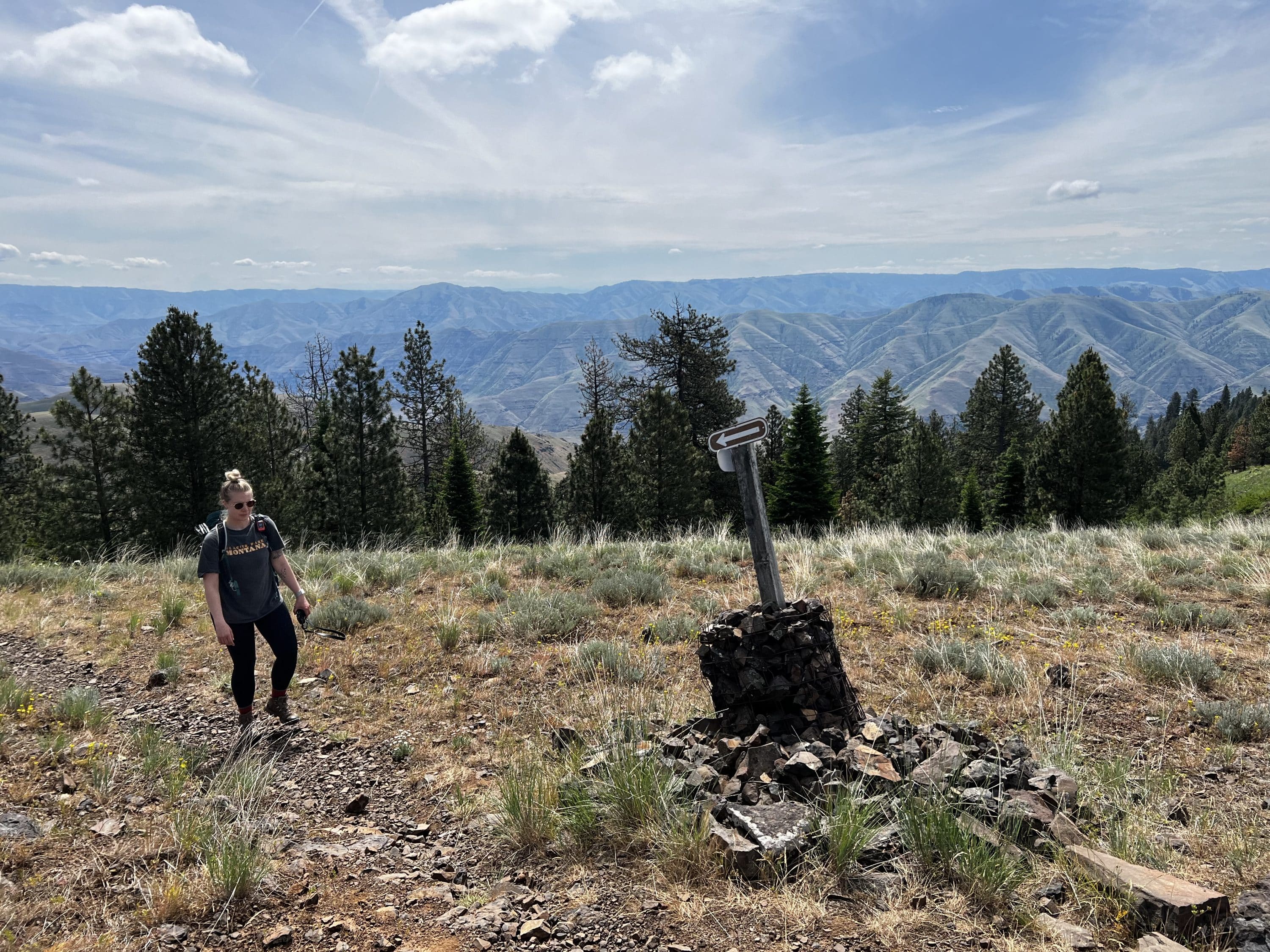 Women hiking to a cairn
