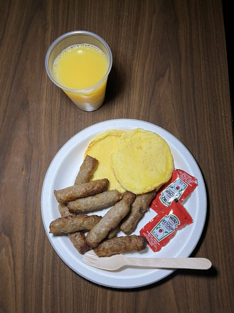 Sausages, eggs, ketchup, and orange juice