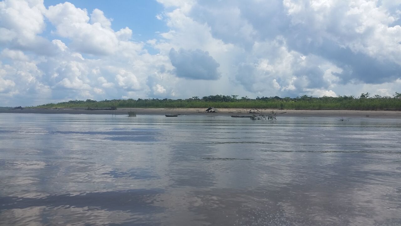 Clouds reflected in the blue water of the Amazon.