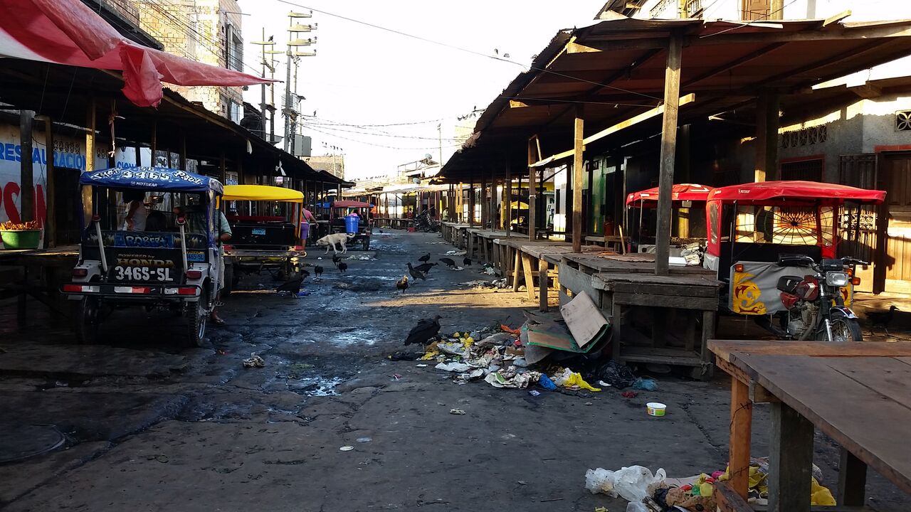 wooden tables and debris in iquitos market.