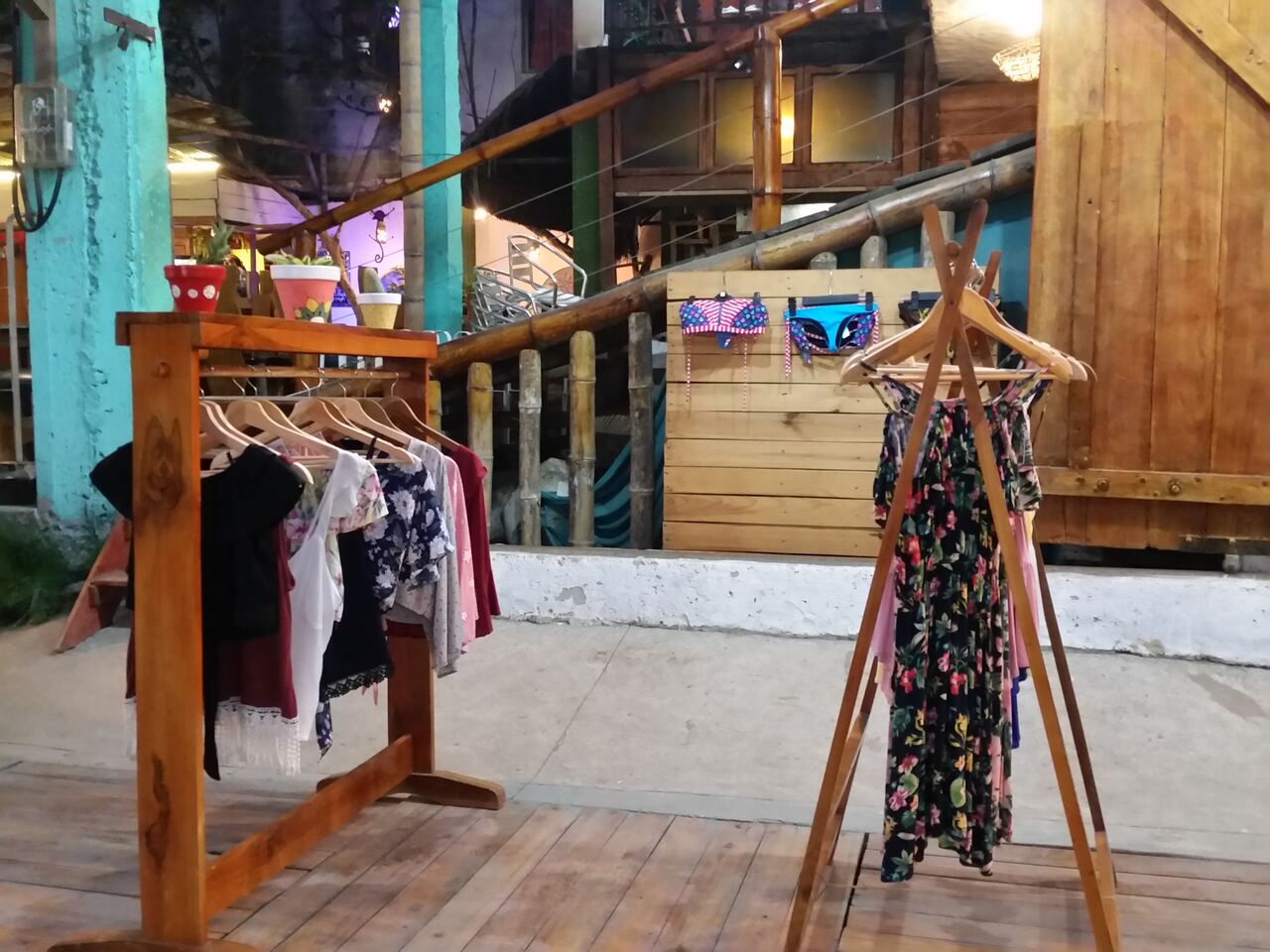Floral pattern beach clothing for sale on wooden racks in Montañita.