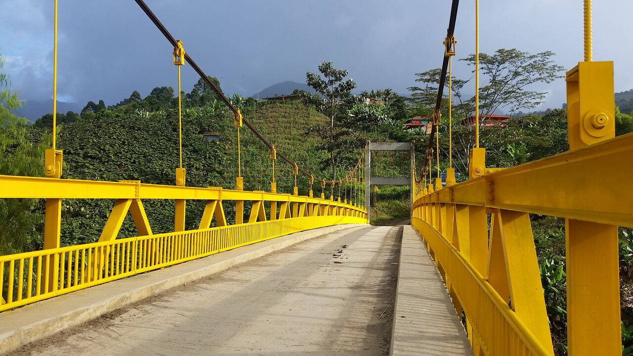 Yellow bridge to countryside in Jardin Colombia.