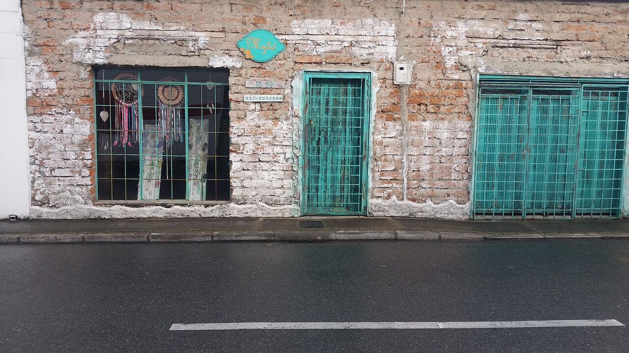 Storefront and green door in the El Pablado neighborhood of Medellin.