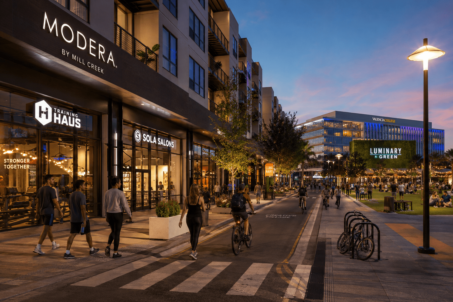 Street-level evening view of Modera Creative Village, active retail storefronts, pedestrians and cyclists beside Luminary Green in Downtown Orlando.