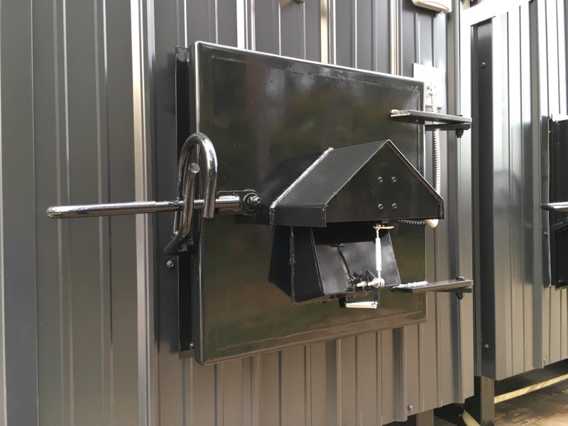 Damper and solenoid in the door of the wood boiler.