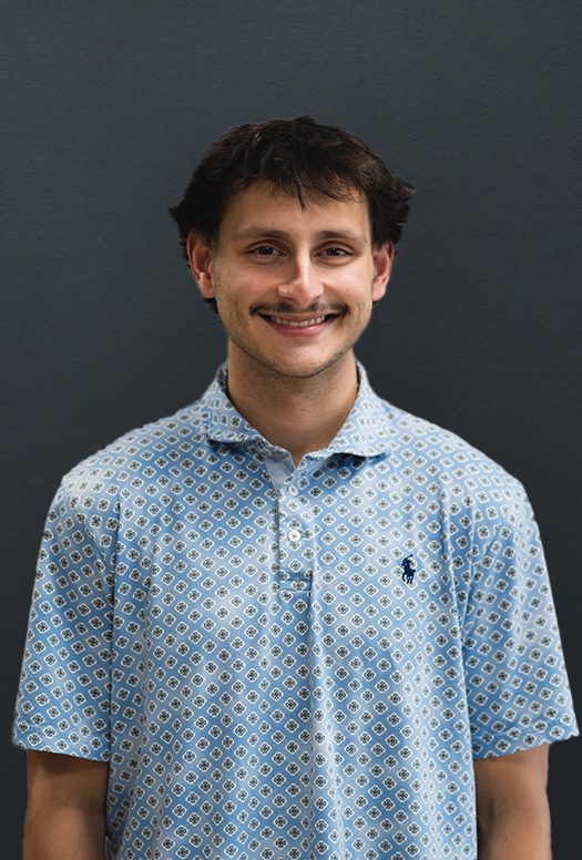 Friendly casual portrait of a man in a patterned button up shirt captured with soft even lighting